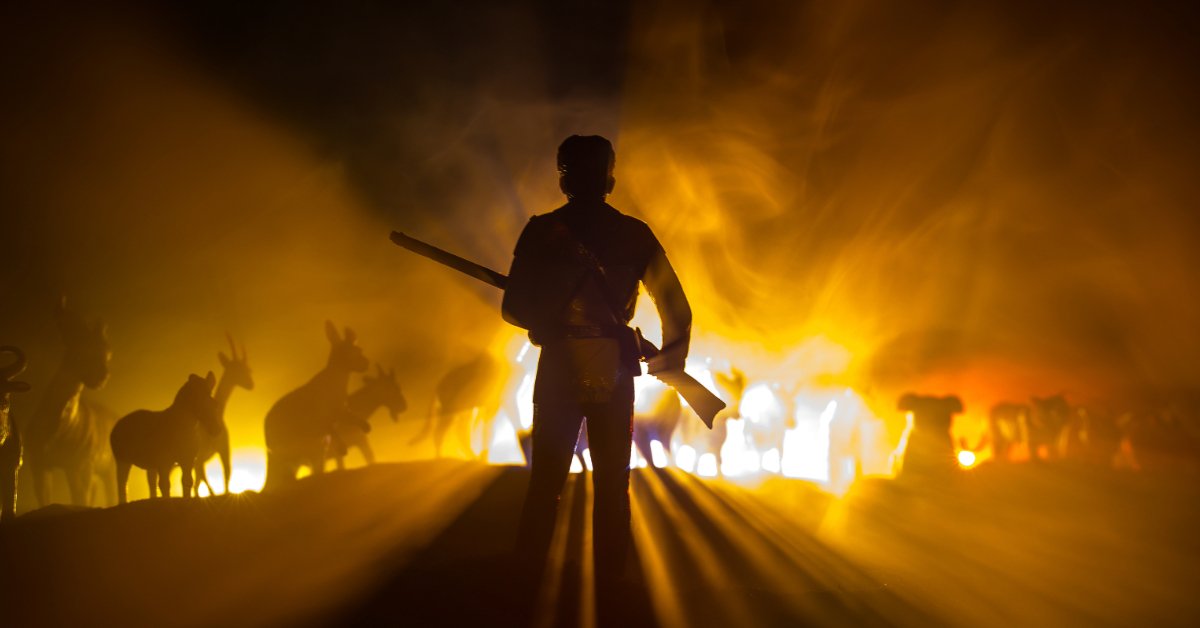 poacher at night holding a rifle